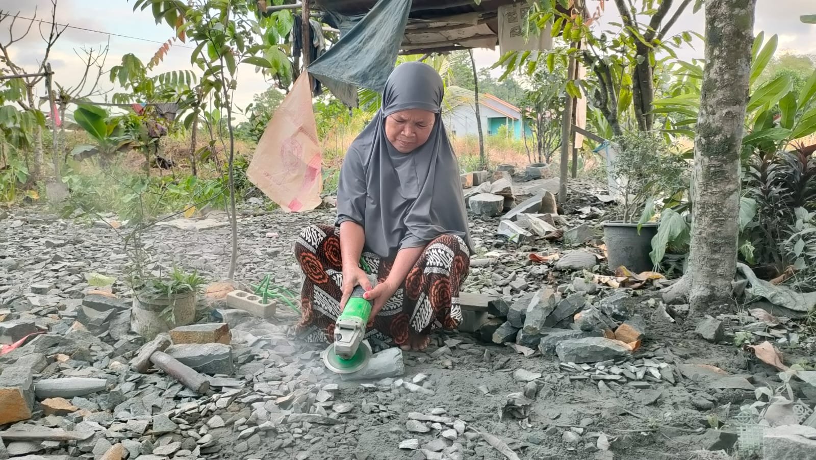 Nenek Jumliah membuat aluk-aluk untuk lesung batu/Foto Bung Ranie