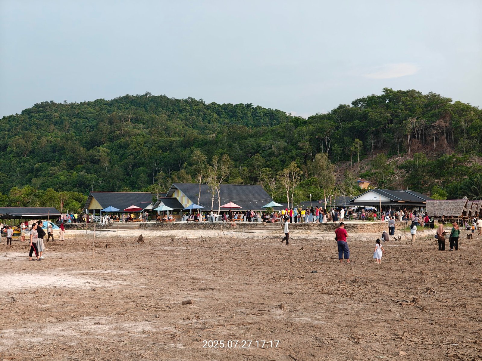 Pengunjung Danau Sebedang berjalan di atas lumpur kering akibat kemarau, Minggu 27 Juli 2025/Foto Jejaring Kalbar