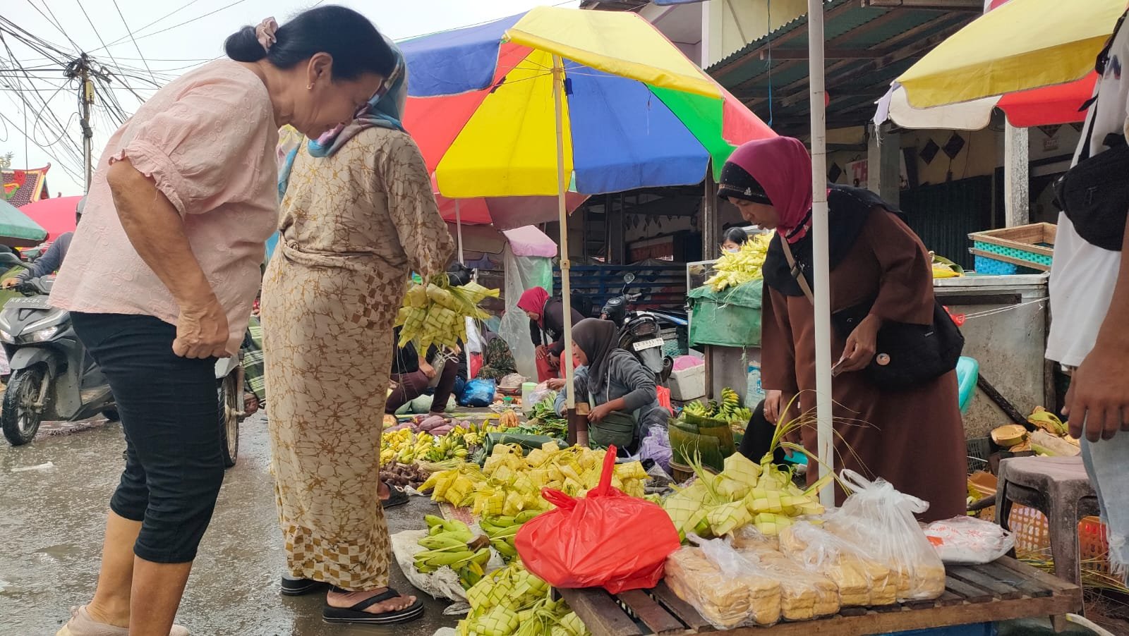Orang membeli ketupat menjelang tradisi robo-robo besok di Pasar Pagi Sungai Pinyuh.